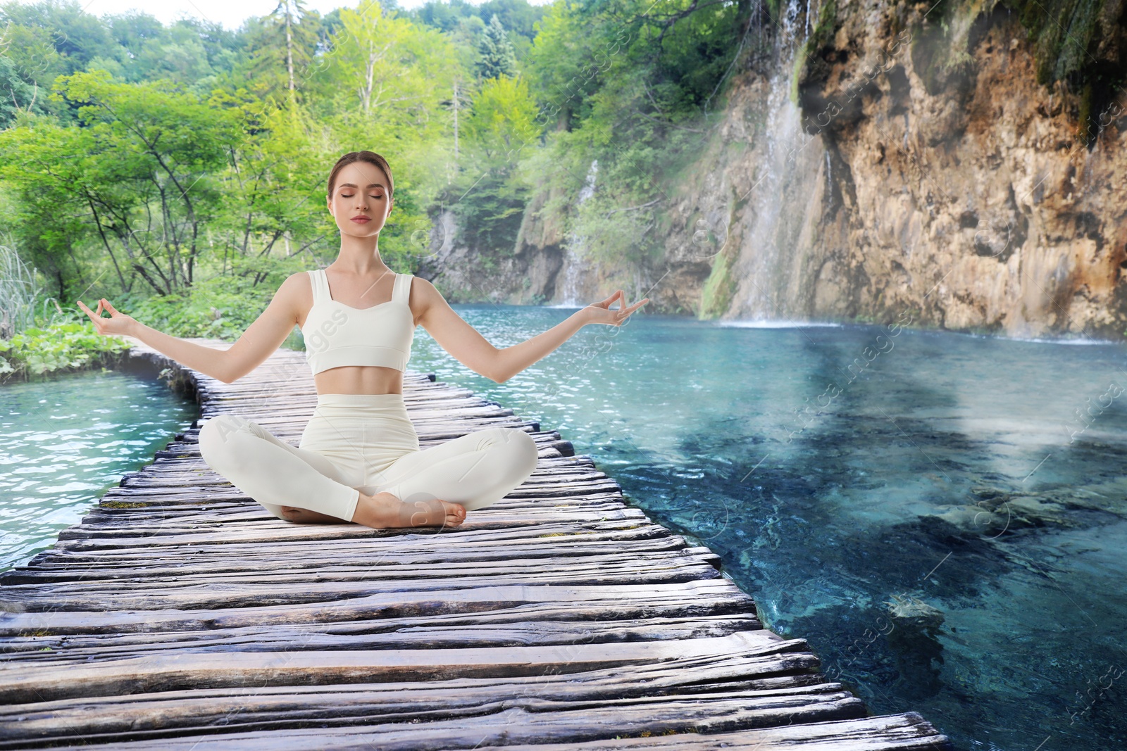 Image of Woman meditating on wooden bridge near river in mountains, space for text