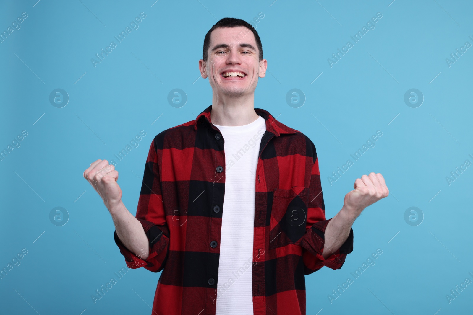 Photo of Portrait of surprised man on light blue background