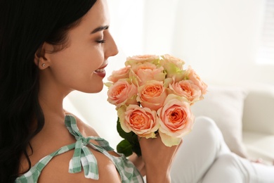Young woman with beautiful bouquet indoors, closeup