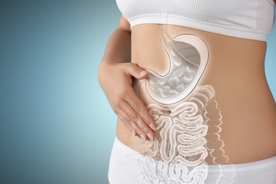 Image of Woman with healthy digestive system on light blue background, closeup. Illustration of gastrointestinal tract