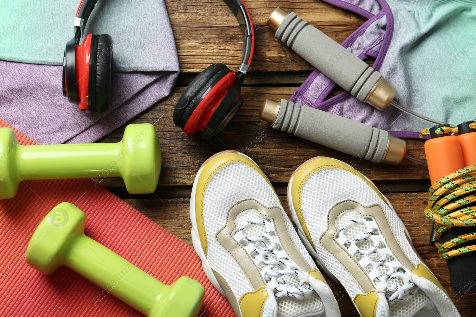 Photo of Set of fitness equipment and accessories on wooden background, flat lay