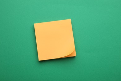 Empty notes on green background, top view. Space for text