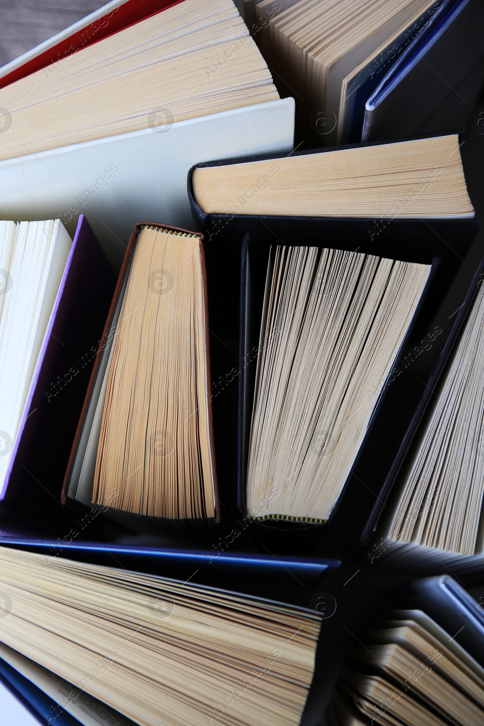 Photo of Collection of different hardcover books, closeup view