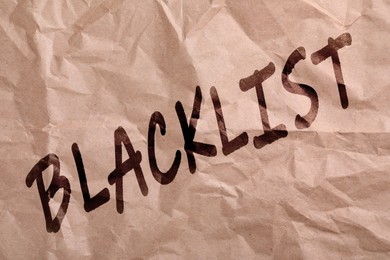Image of Black word Blacklist on crumpled beige paper