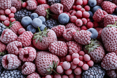 Photo of Mix of different frozen berries as background, top view