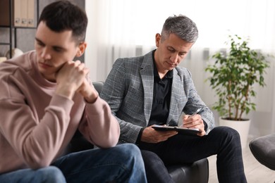 Professional psychotherapist working with patient in office