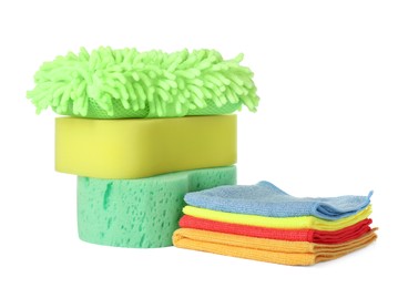 Photo of Sponges, cloths and car wash mitt on white background