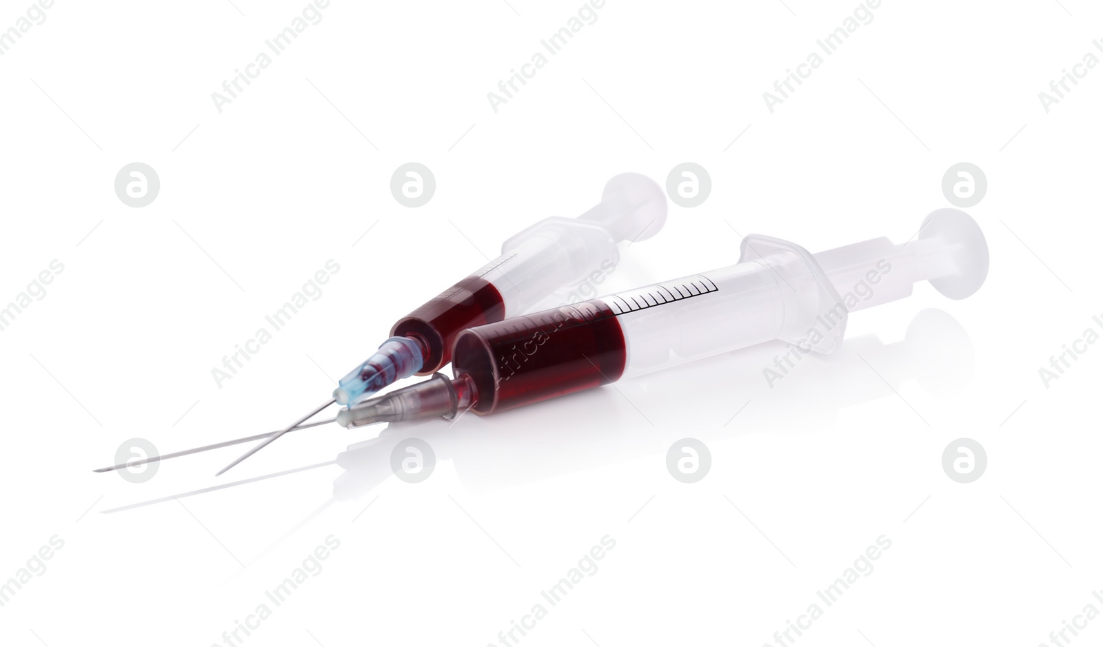 Photo of Plastic syringes with blood on white background