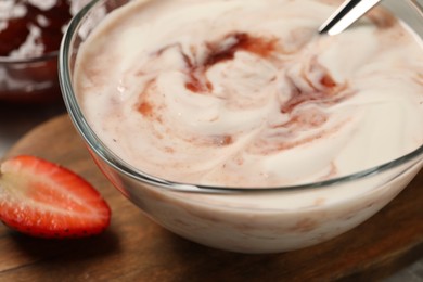 Tasty yoghurt with jam and strawberry on table, closeup