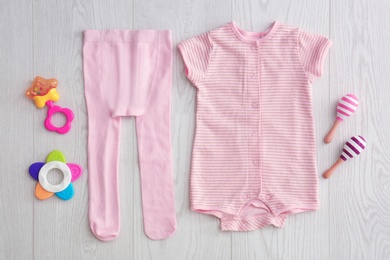 Photo of Flat lay composition with fashionable children's clothes on wooden background