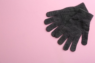 Photo of Pair of stylish woolen gloves on pink background, flat lay. Space for text