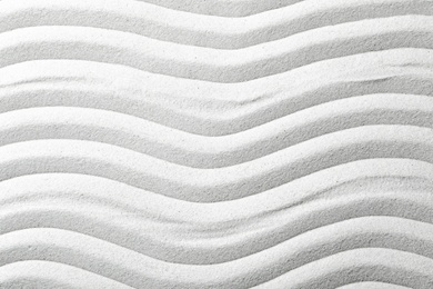 Zen garden pattern on sand as background, top view. Meditation and harmony