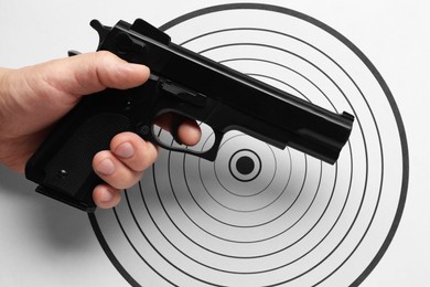 Photo of Man with handgun near shooting target, top view