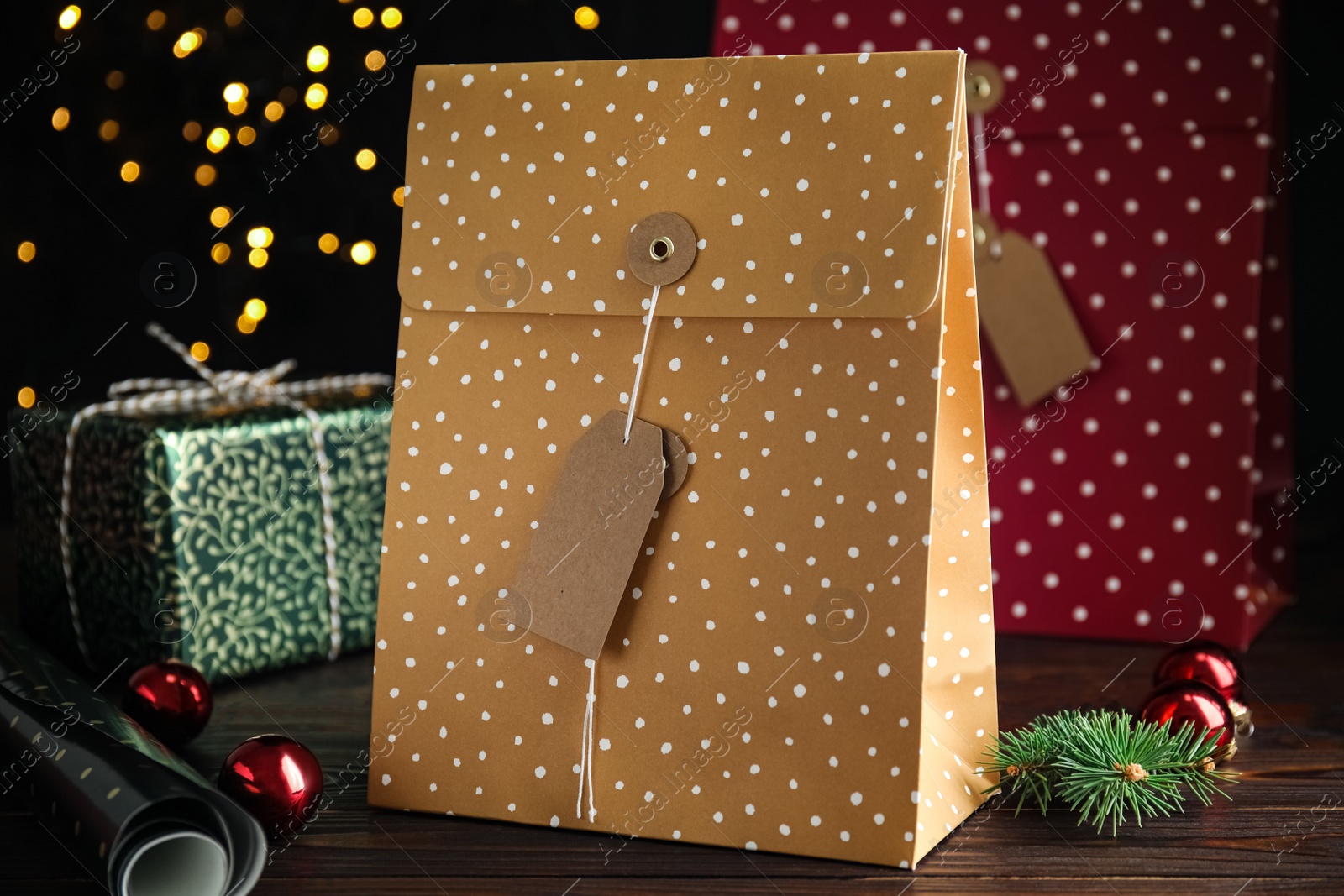 Photo of Beautifully decorated Christmas present on wooden table