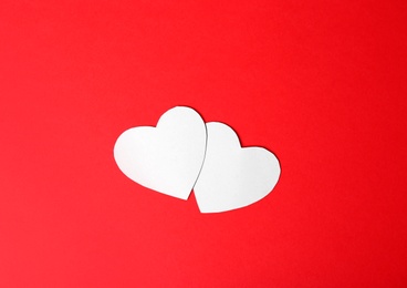 Paper hearts on color background, top view