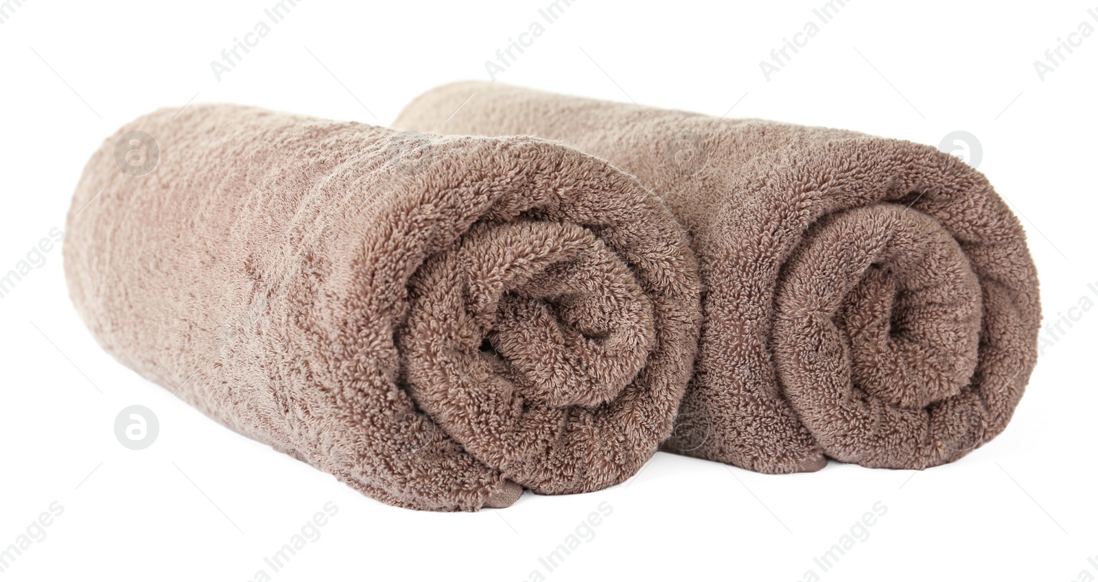 Photo of Rolled clean brown towels on white background