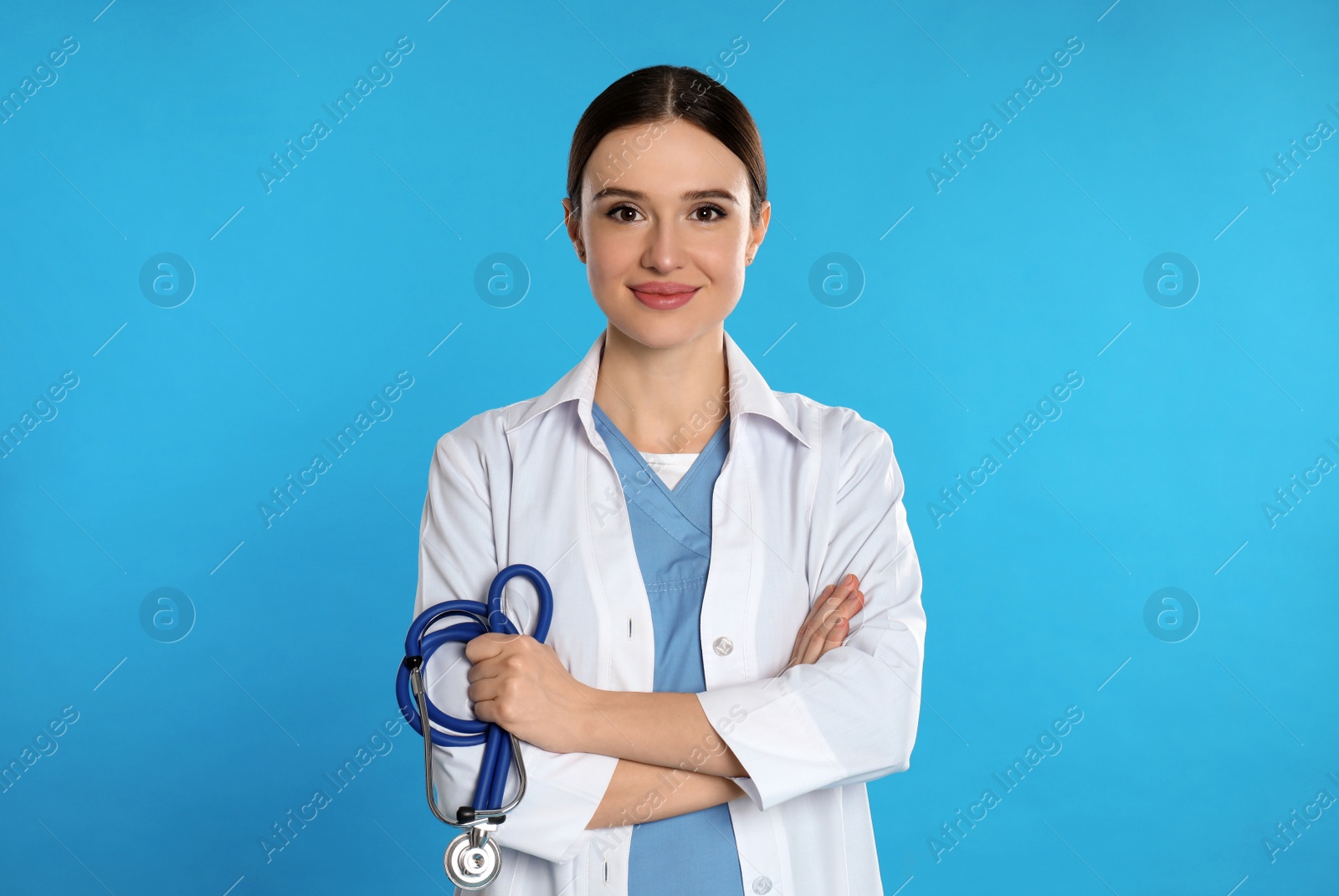 Photo of Portrait of doctor with stethoscope on blue background