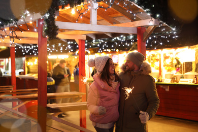 Happy couple spending time at Christmas fair