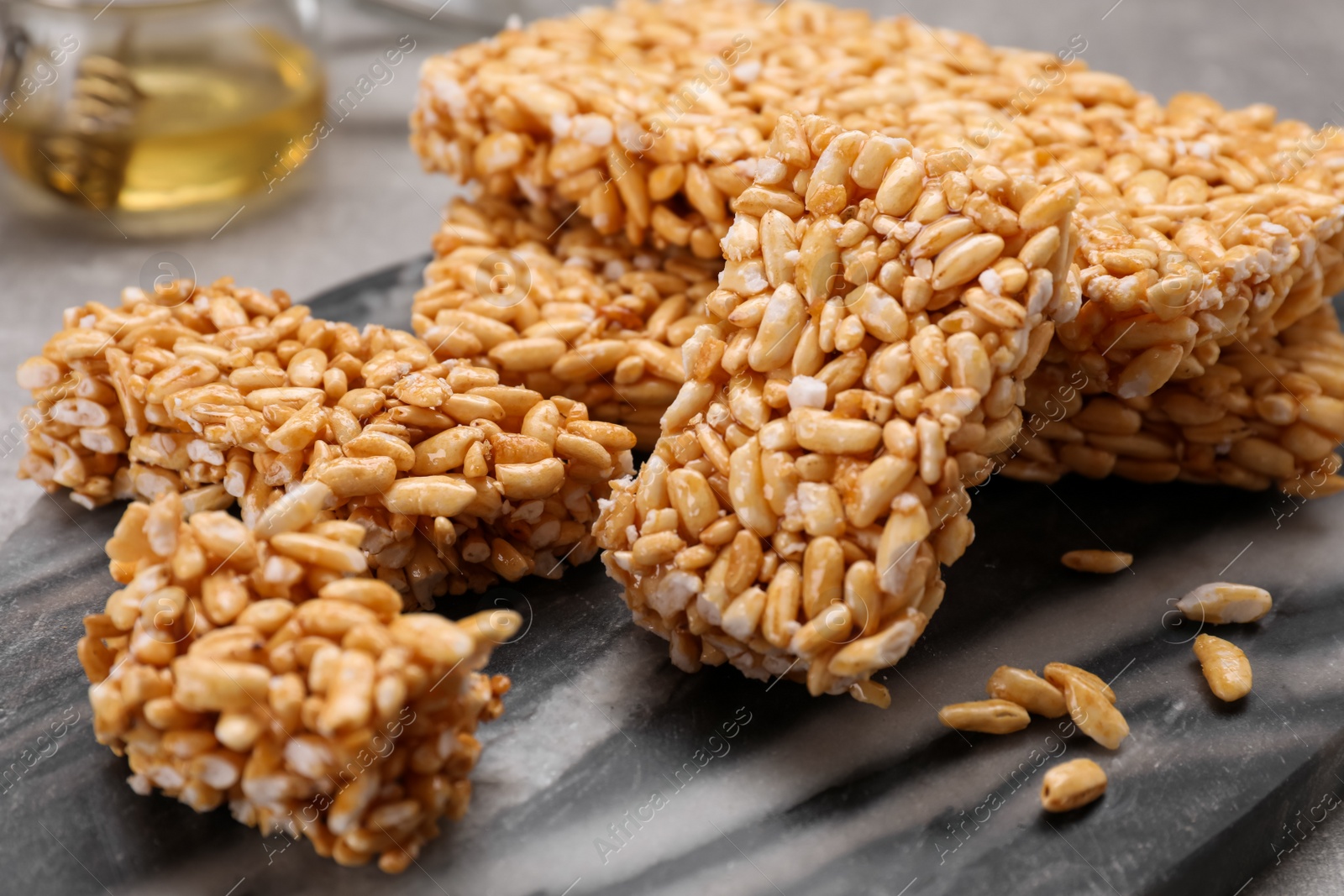 Photo of Puffed rice bars (kozinaki) on board, closeup