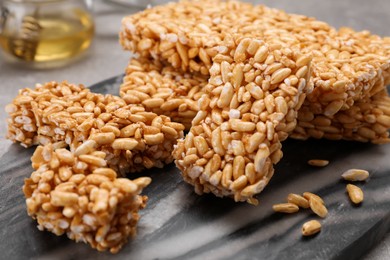 Photo of Puffed rice bars (kozinaki) on board, closeup