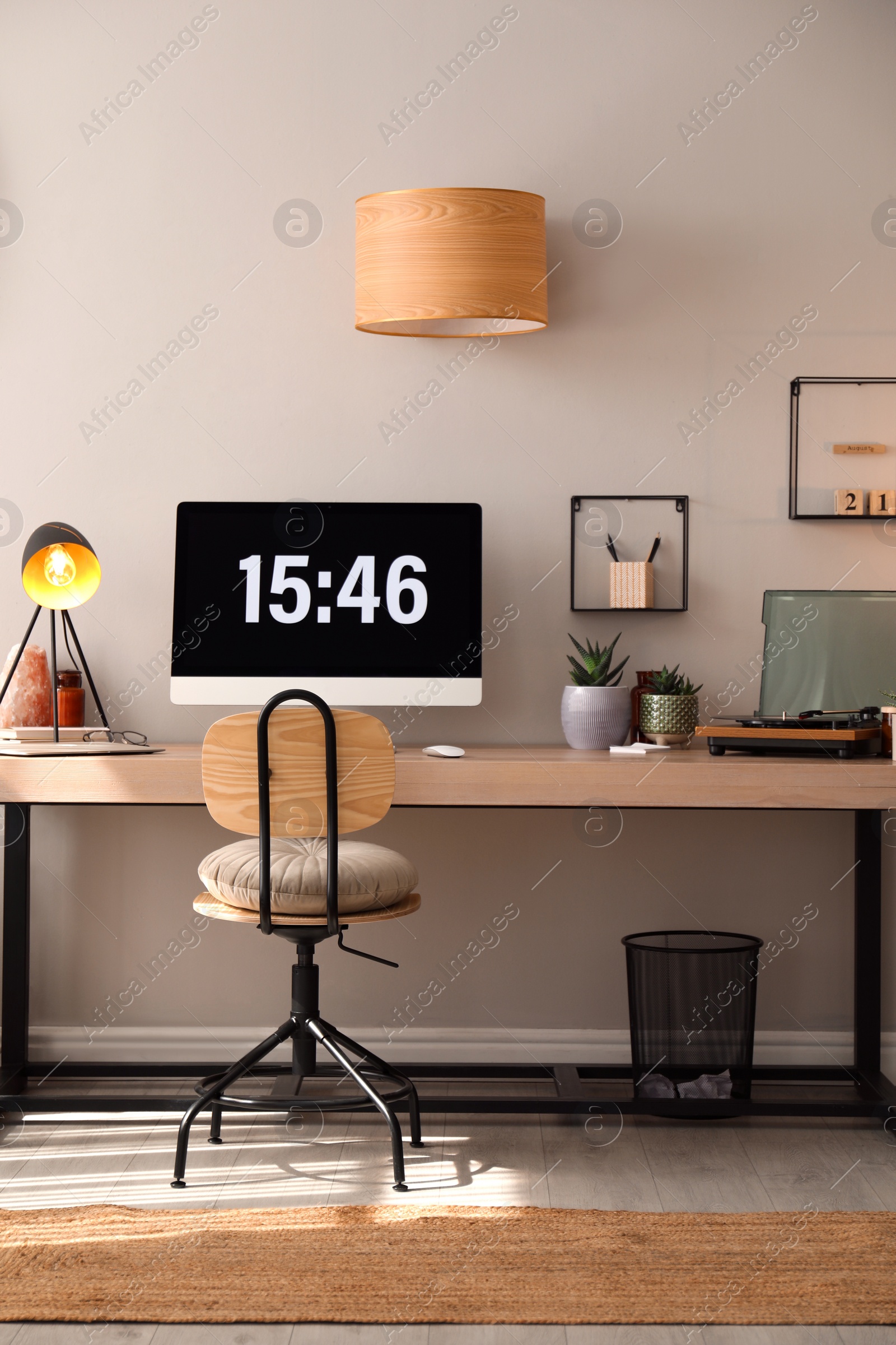 Photo of Room interior with comfortable workplace. Modern computer on wooden desk