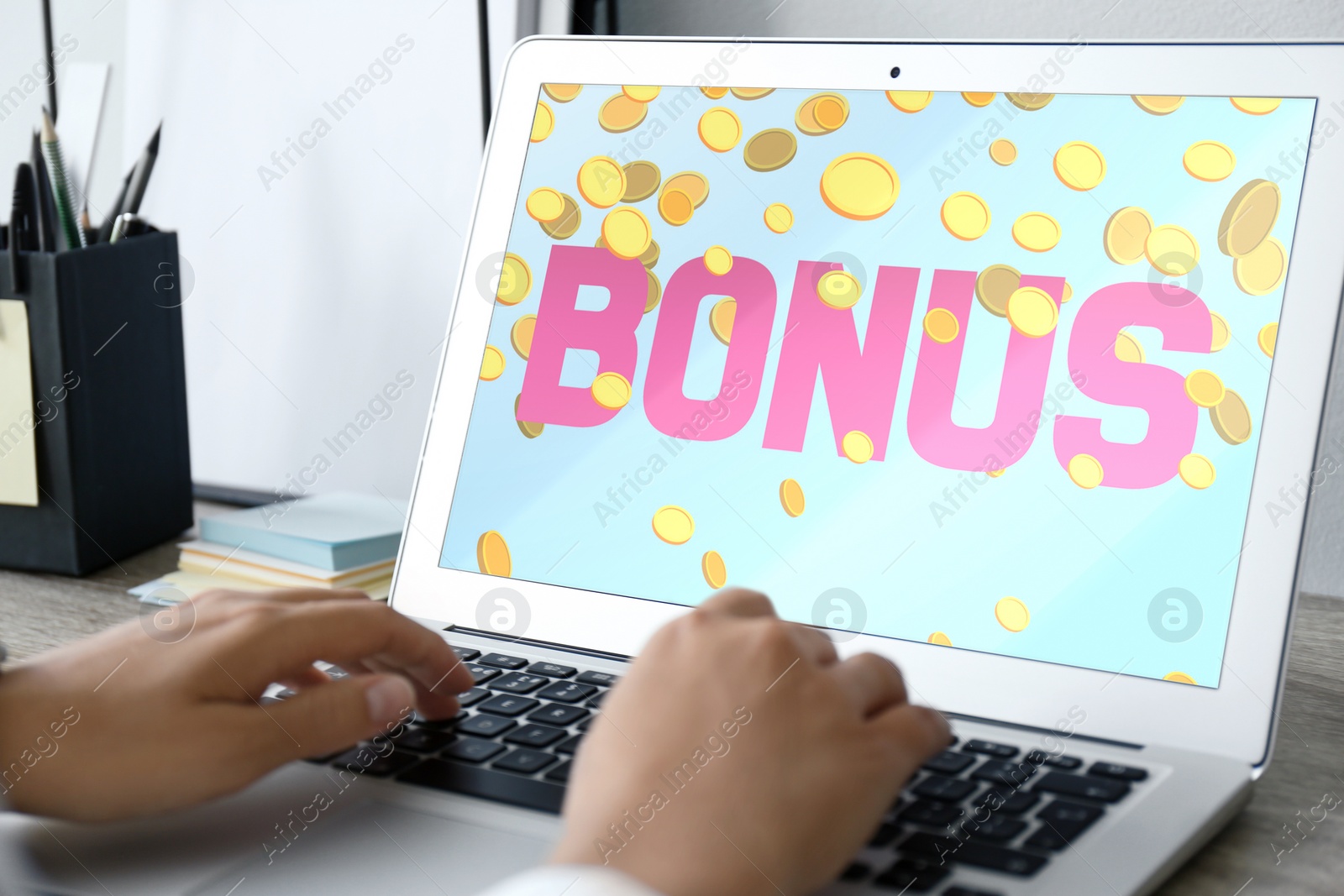 Image of Bonus gaining. Woman using laptop at table, closeup. Illustration of falling coins and word on device screen