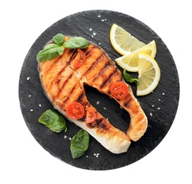 Slate plate with tasty salmon steak on white background