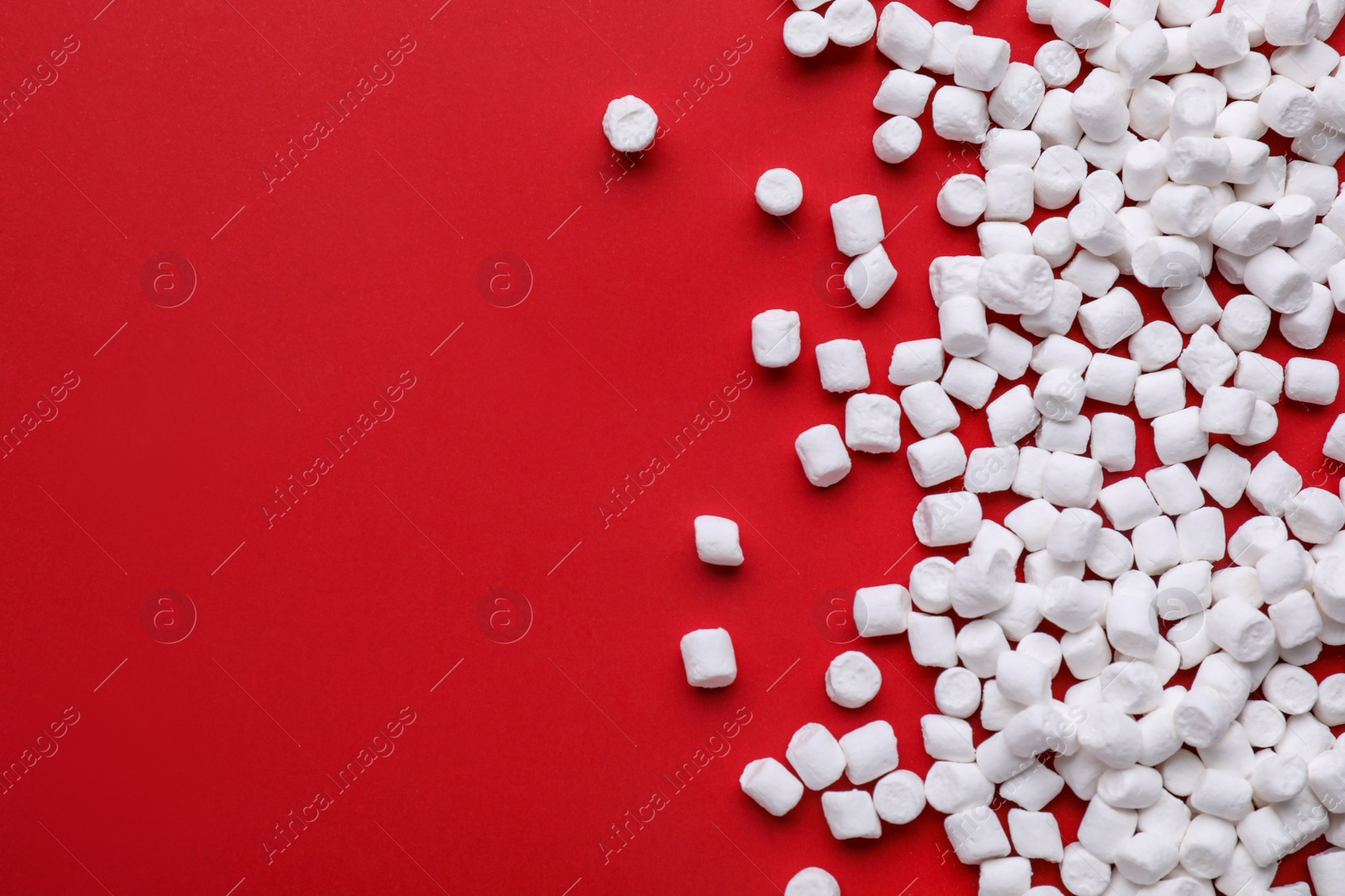 Photo of Delicious marshmallows on red background, flat lay. Space for text