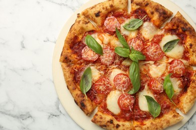 Photo of Delicious Margherita pizza on white marble table, top view