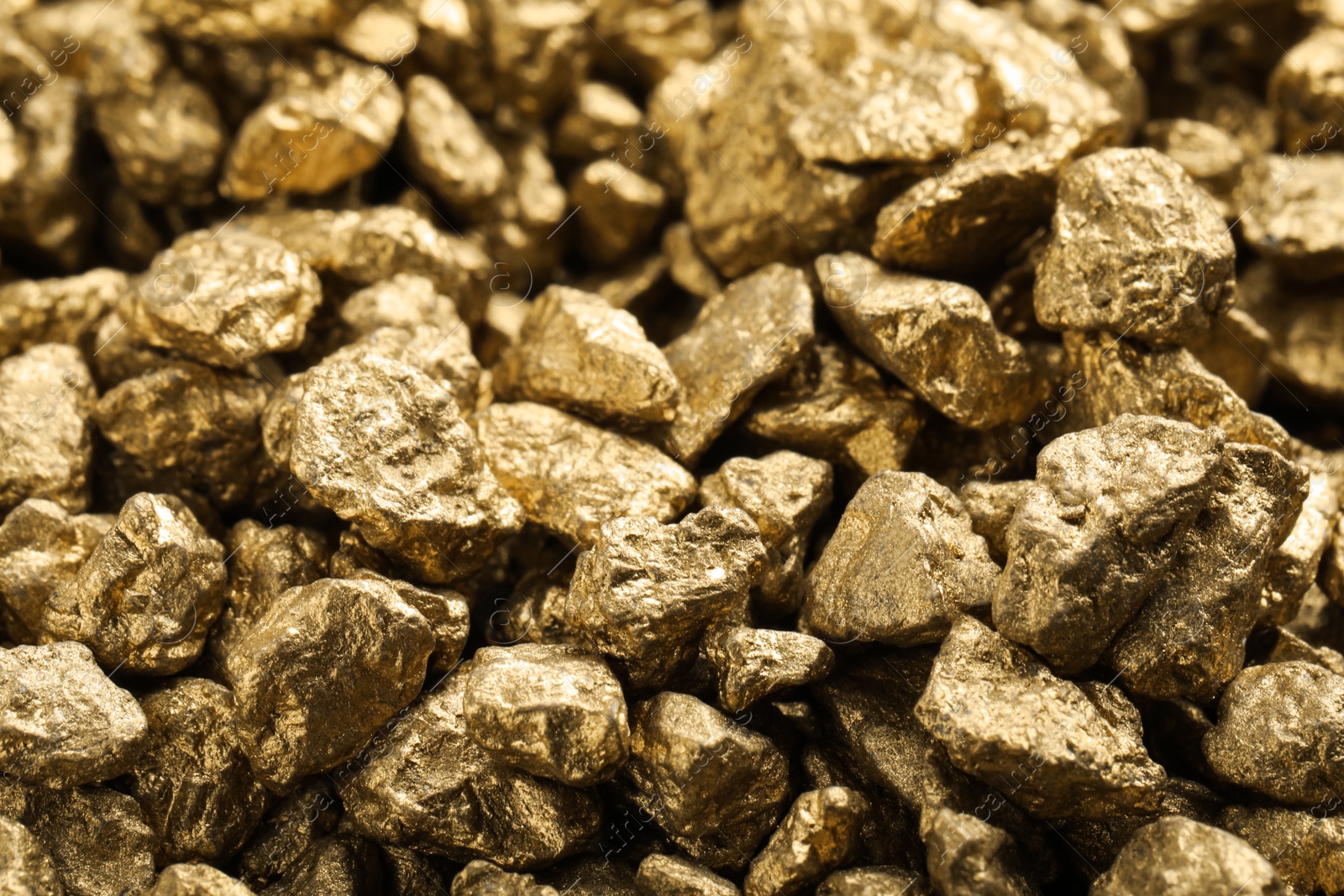 Photo of Pile of gold nuggets as background, closeup