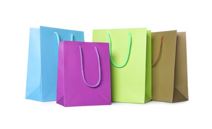 Photo of Colorful paper shopping bags isolated on white