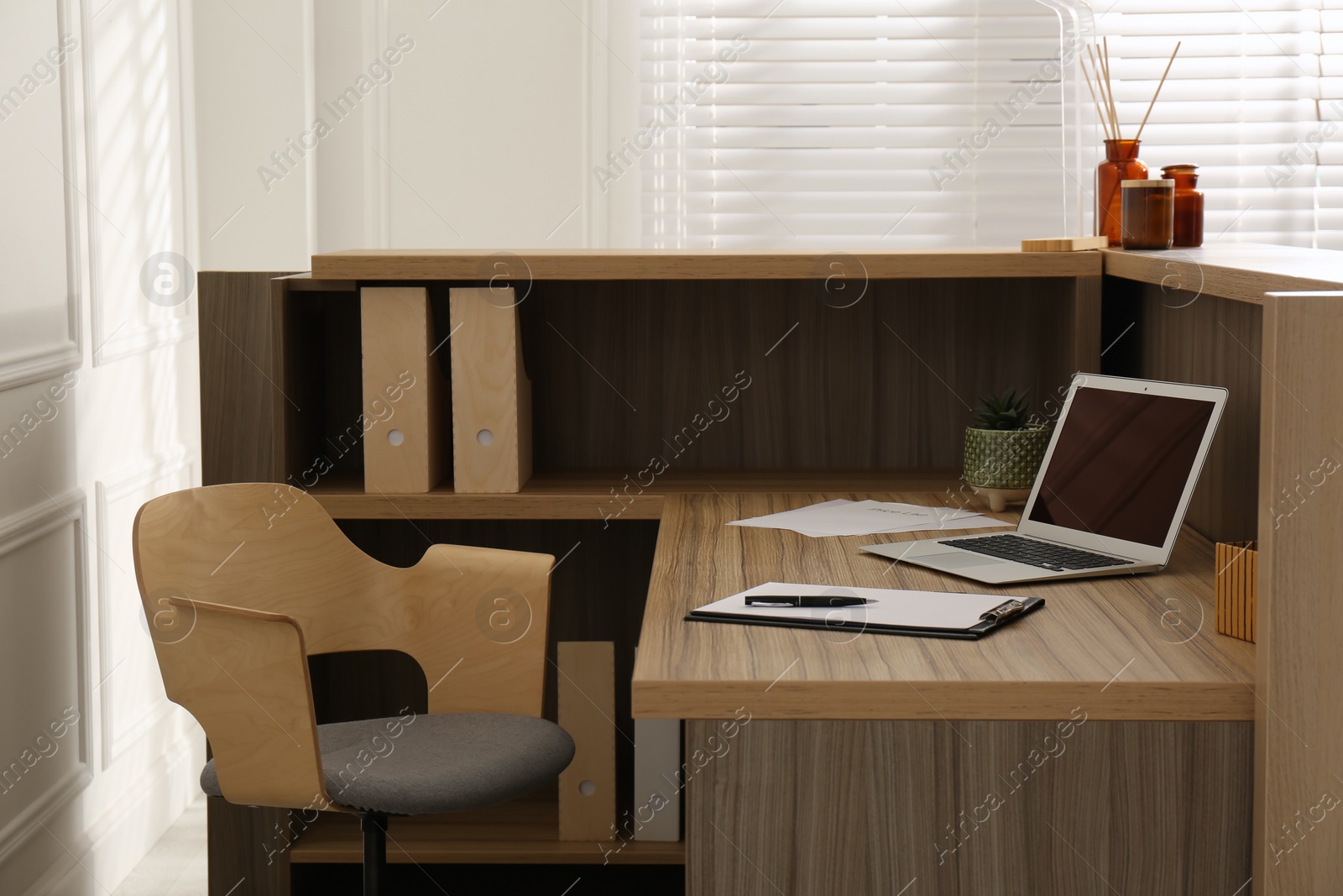 Photo of Receptionist's workplace with laptop in hotel. Interior design