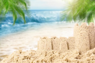 Image of Sand castle on ocean beach, closeup with space for text. Outdoor play