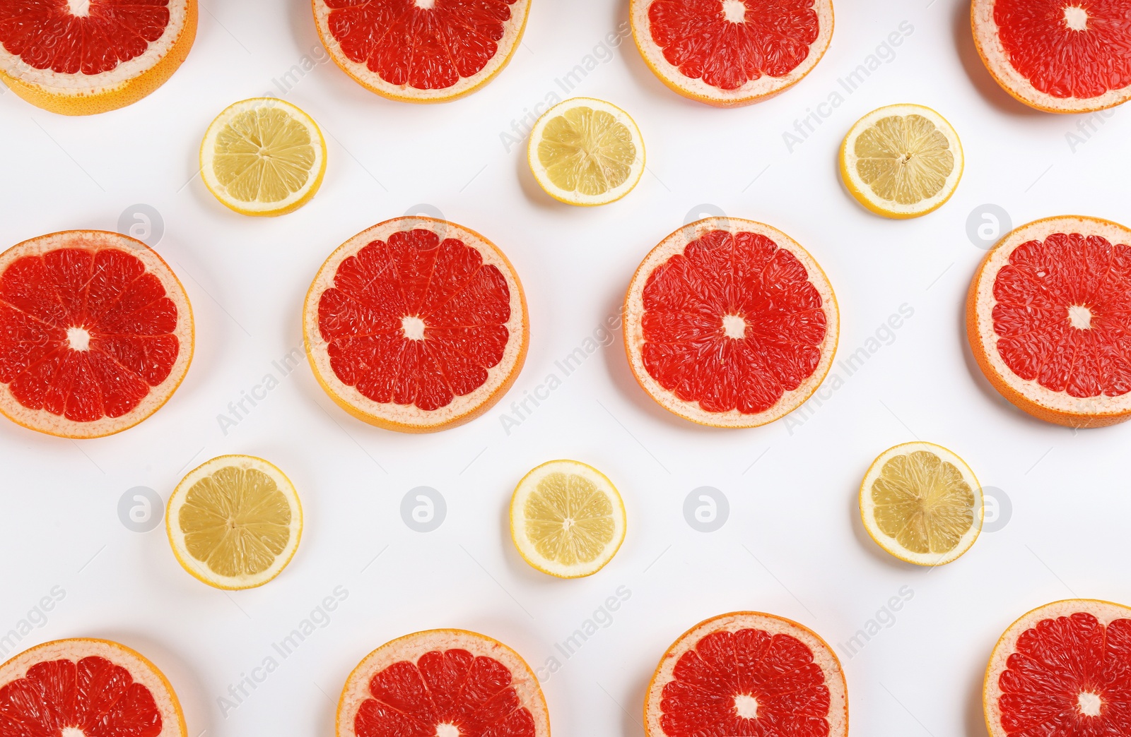 Photo of Flat lay composition with tasty ripe grapefruit slices on white background