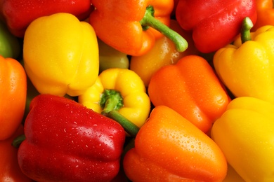 Photo of Wet ripe colorful bell peppers as background, closeup