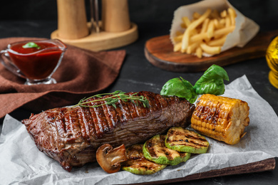 Photo of Delicious beef tenderloin served on table, closeup