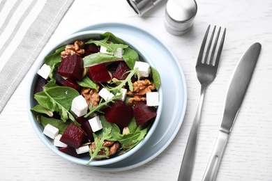 Delicious beet salad served on white wooden table, flat lay