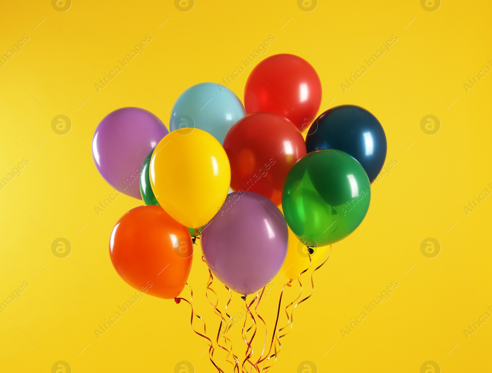 Photo of Bunch of bright balloons on color background. Celebration time