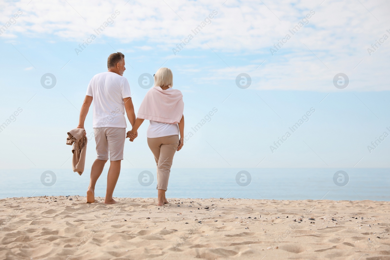 Photo of Mature couple spending time together on sea beach