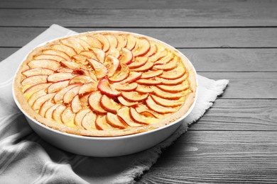 Tasty apple pie on grey wooden table