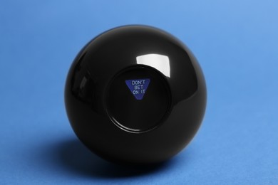 Photo of Magic eight ball with prediction Donʼt Bet On It on blue background