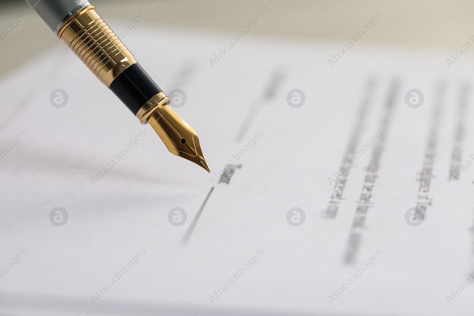 Photo of Signing document with fountain pen, closeup. Notary services