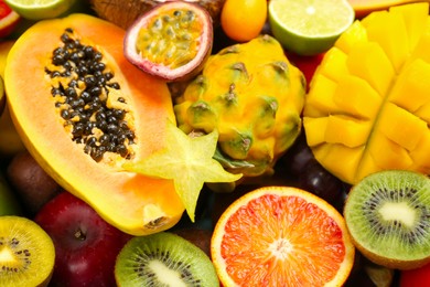 Photo of Many different delicious exotic fruits as background, closeup