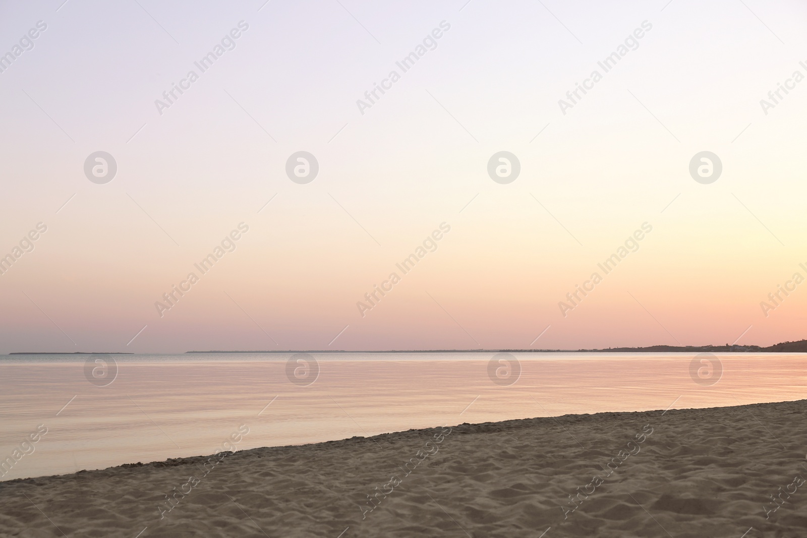 Photo of Sandy beach near sea at summer sunset