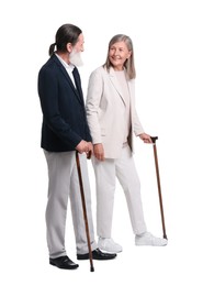 Photo of Senior man and woman with walking canes on white background