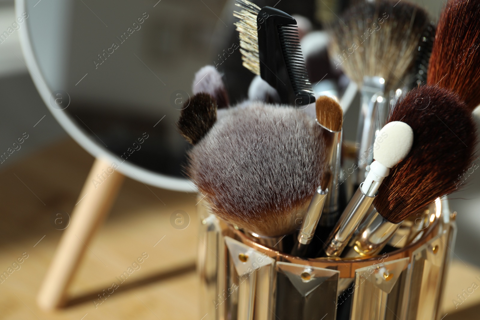 Photo of Set of professional brushes and mirror, closeup. Space for text