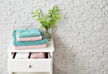 Small table with clean towels in bathroom