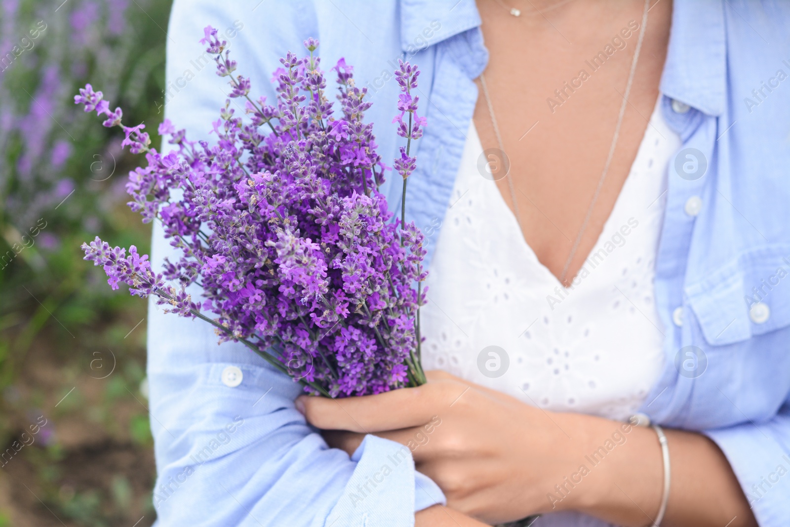 Photo of Woman with bouquet of beautiful lavender flowers outdoors, closeup