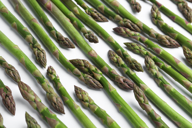Fresh raw asparagus on white background, above view