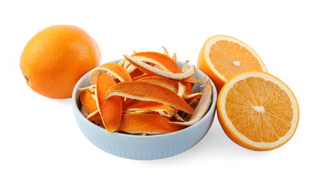 Bowl with dry orange peels and fresh fruits isolated on white